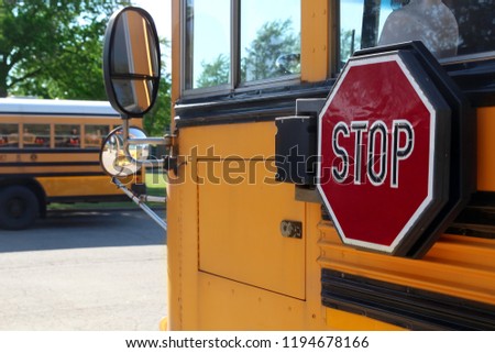 The Yellow school bus with stop sign