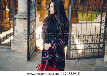 stylish girl exploring the city and park in the autumn