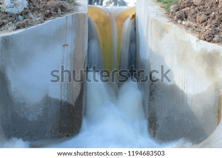 The water flows out of the irrigation canal.