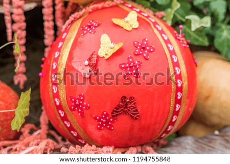orange pumpkin with colorful ribbons and butterflies. halloween concept