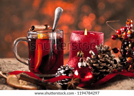 Mulled wine in glasses with spices on wooden table