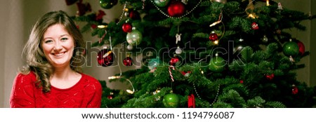 Woman Wrapping and Decorating Christmas Present