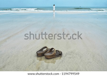 Summer vacation concept. Flip flops on a sandy ocean beach,Beach shoes, select focus only on the spot in this picture only