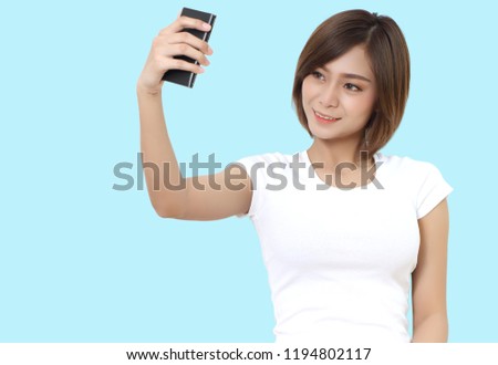 beautiful young asian woman holding smart phone on hand
