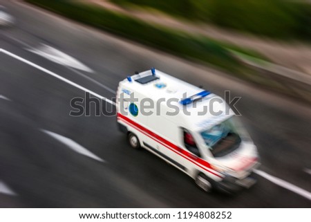 Ambulance in the city on a blurred background .  Intentional motion blur