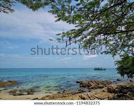 Holiday background photo, picture from Samet island in Thailand. Beautiful beach and blue sky with a boat in water. Sunny day, holiday picture. Tress line 