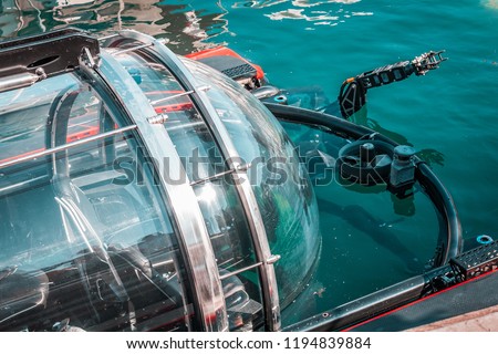 High tech mini submarine, preparing for underwater biology research. Marine life, seeking fish species and water data. Royalty-Free Stock Photo #1194839884