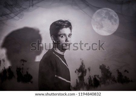 A mysterious young man under the full moon and fog