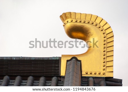 Gold-encrusted ornamentation on a temple roof in Hachinohe, Aomori, Japan.