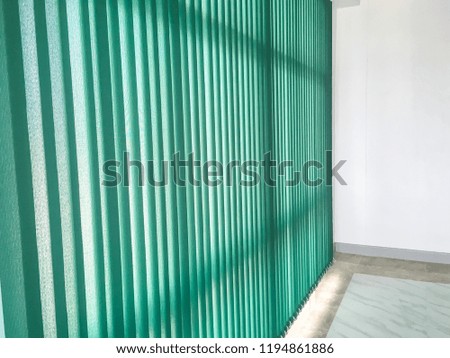 Closeup green jalousie,curtain, Louvers , shade or shutter background open slightly see the soft light into the empty white room.pattern for design background.