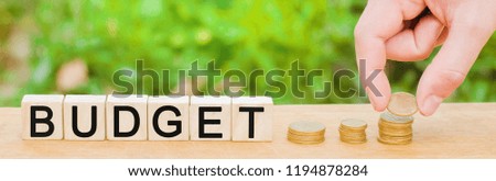 The concept of accumulating money in the family budget. Man puts coins into a pile. Annual funds, marketing plan, banking deposit for insurance, education and retirement concepts.