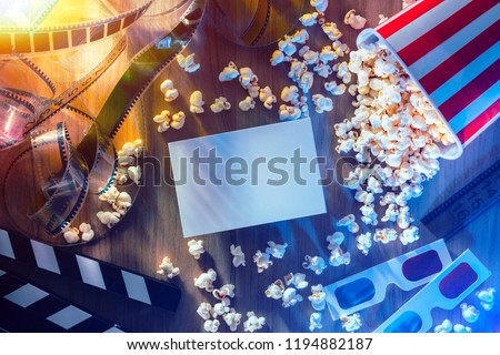 Blank cinema promo card or ticket, popcorn, filmstrip and clapper, movies and entertainment concept