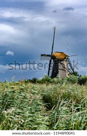Old windmill surrounded by grass