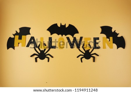 Happy Halloween on orange background. Also have a few spiders and bats on sides.Trick or treating. American holiday. Celebrating