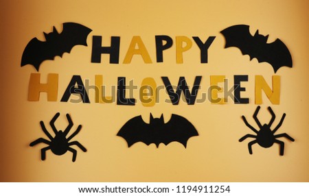A happy halloween sign with some black bats and spiders. Trick or treating. American holiday. Witches and cauldrons. Orange and black. Scare. Fear. Ghost