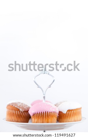 Small muffins with icing sugar against a white background