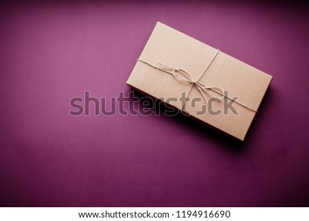 Gift box wrapped in colored background.