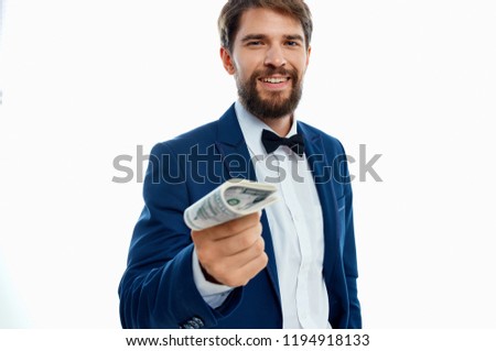  A man looks into the camera and holds a bank note                    