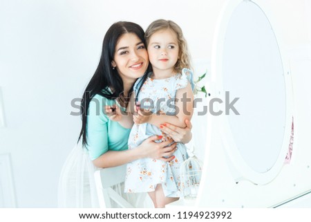 Cute girls looking into mirror and smiling