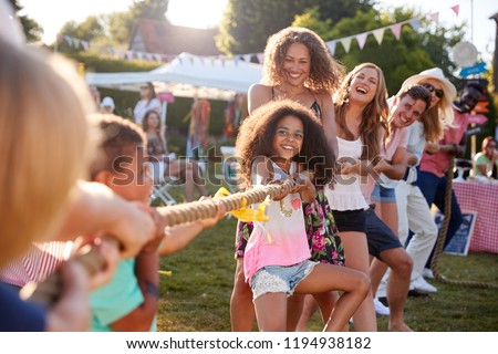 Game Of Tug Of War At Summer Garden Fete Royalty-Free Stock Photo #1194938182