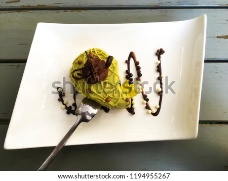 Piece of delicious pistachio cake with chocolate garnish decoration