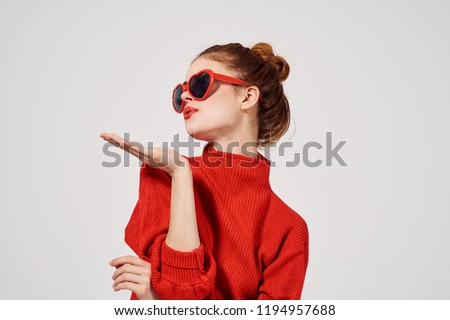 woman in glasses in the shape of a heart and a red sweater                           