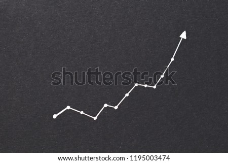 exponential diagram. trend success increase and financial forecast concept. arrow pointing upward on black paper background. Royalty-Free Stock Photo #1195003474