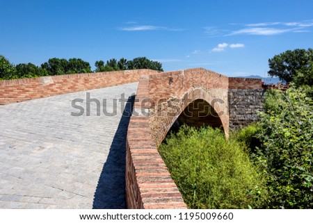 Modern red brick stone bridge with green trees and blue sky in the background - concept architecture traffic road crossing landscape hiking Way of St. James religion Christianity pilgrimage church