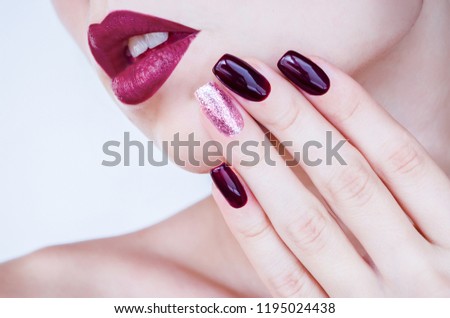 
fashion photo beautiful woman with burgundy lipstick and manicure and beautiful design