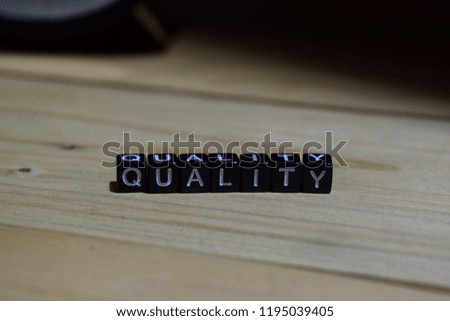 Quality written on wooden blocks. Education and business concept on wooden background