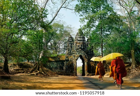monks with umbrella walking in Angkor wat temple,Cambodia Royalty-Free Stock Photo #1195057918