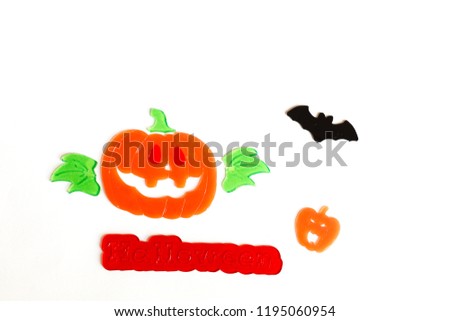Top view of Halloween crafts, pumpkin, bat on white background w