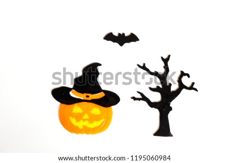 Top view of Halloween crafts, pumpkin, bat, tree on white backgr