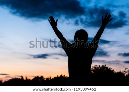 Silhouette woman girl hands up sunset background