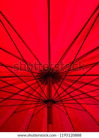 Under a red umbrella