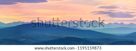 Wide angle panorama autumn forest,misty hills mountain tops in pink dawn Royalty-Free Stock Photo #1195159873