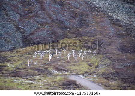 The white crosses of the historic graveyard cemetery, built in 1918 after miners died of the Spanish flu, also known as the 1918 influenza pandemic, in Longyearbyen, Spitsbergen, Svalbard, Norway. Royalty-Free Stock Photo #1195191607