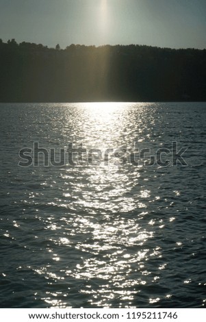 The sun light reflects and make sparkles in the water.
