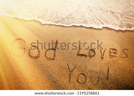 The inscription on the sand God loves you. Christianity, faith.