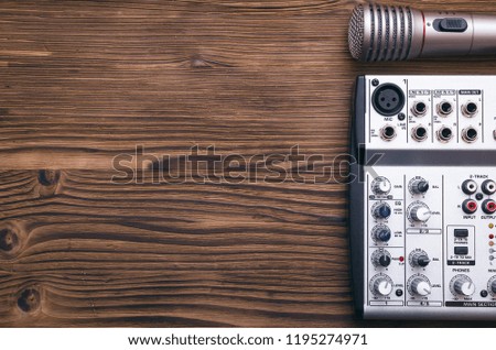 Audio recording studio concept. Microphone and audio sound mixer on the table.