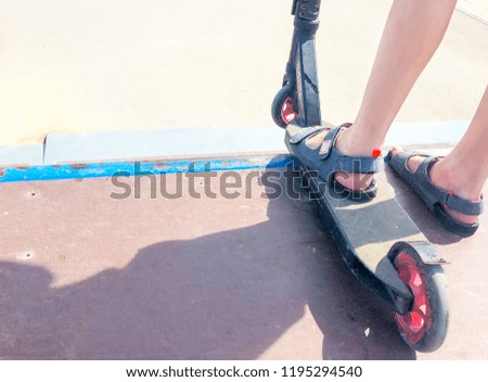 children's feet on a scooter in a  skate parks
