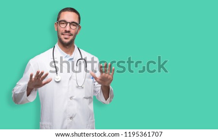 Confident young doctor doing a keep calm gesture