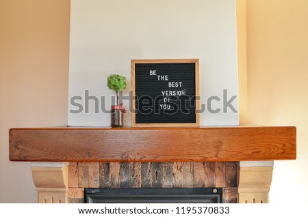 'Be the best version of you' sign standing on the fireplace.