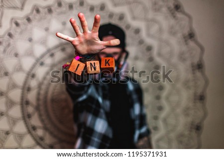Picture of random letters on wooden cubes levitating in the air with a blury man in a background