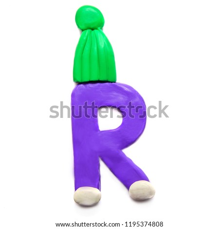 Purple plasticine letter R of the English alphabet in a green winter hat on a white background