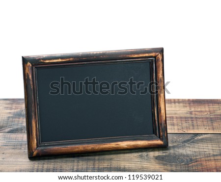 empty blackboard with wooden frame is on the table