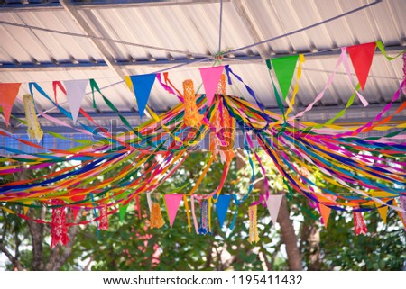 Colorful flags hanging in a beautiful line in the carnival.