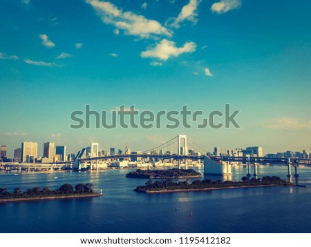 Beautiful cityscape with architecture building and rainbow bridge in tokyo city japan on blue sky and white cloud