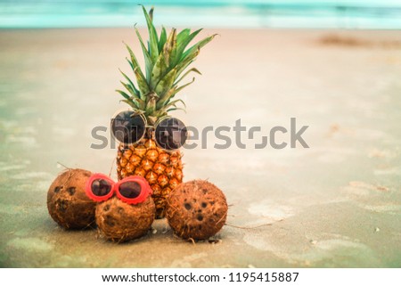 Cute Pineapple and Coconuts Wearing Sunglasses Relaxing By The Ocean
