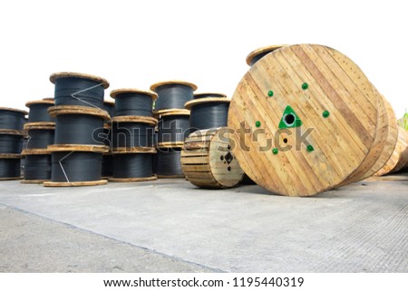 Wooden Coils Of Electric Cable Outdoor. High and low voltage cables in the storage. Royalty-Free Stock Photo #1195440319